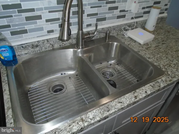 a stove top oven sitting inside of a kitchen