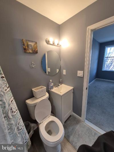 2903 Jefferson Street Baltimore, MD 21205 - Photo 24 of 48 a bathroom with a toilet a sink and mirror