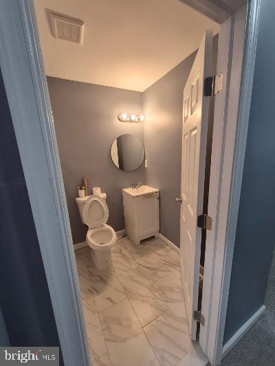 2903 Jefferson Street Baltimore, MD 21205 - Photo 27 of 48 a bathroom with a toilet and a mirror