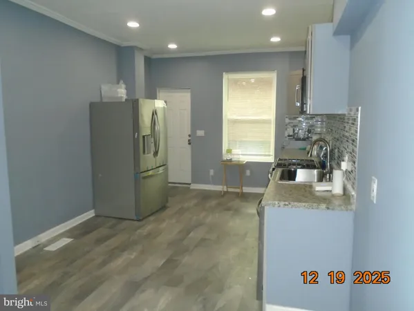 a kitchen with stainless steel appliances granite countertop a stove sink and cabinets