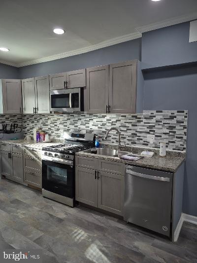 2903 Jefferson Street Baltimore, MD 21205 - Photo 10 of 48 a kitchen with stainless steel appliances granite countertop a stove sink and cabinets