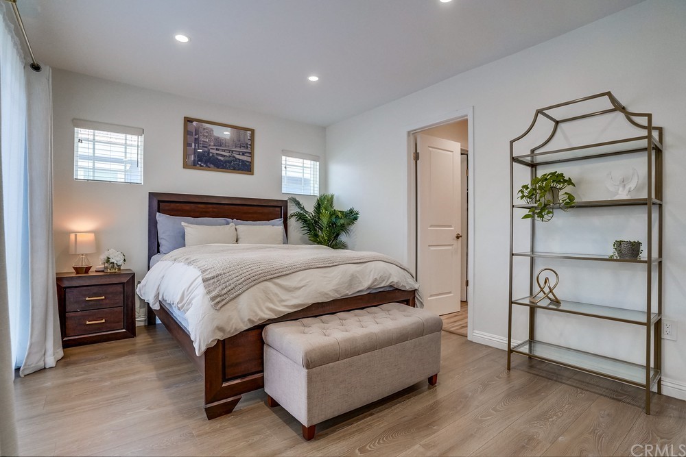 9559 Firestone Boulevard, Unit D Downey, CA 90241 - Photo 17 of 24 a bedroom with a bed and a painting on the wall