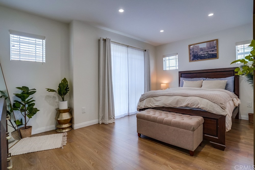 9559 Firestone Boulevard, Unit D Downey, CA 90241 - Photo 21 of 24 a bedroom with a bed and a potted plant