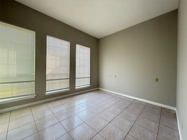 a bathroom with a granite countertop sink a toilet and a mirror