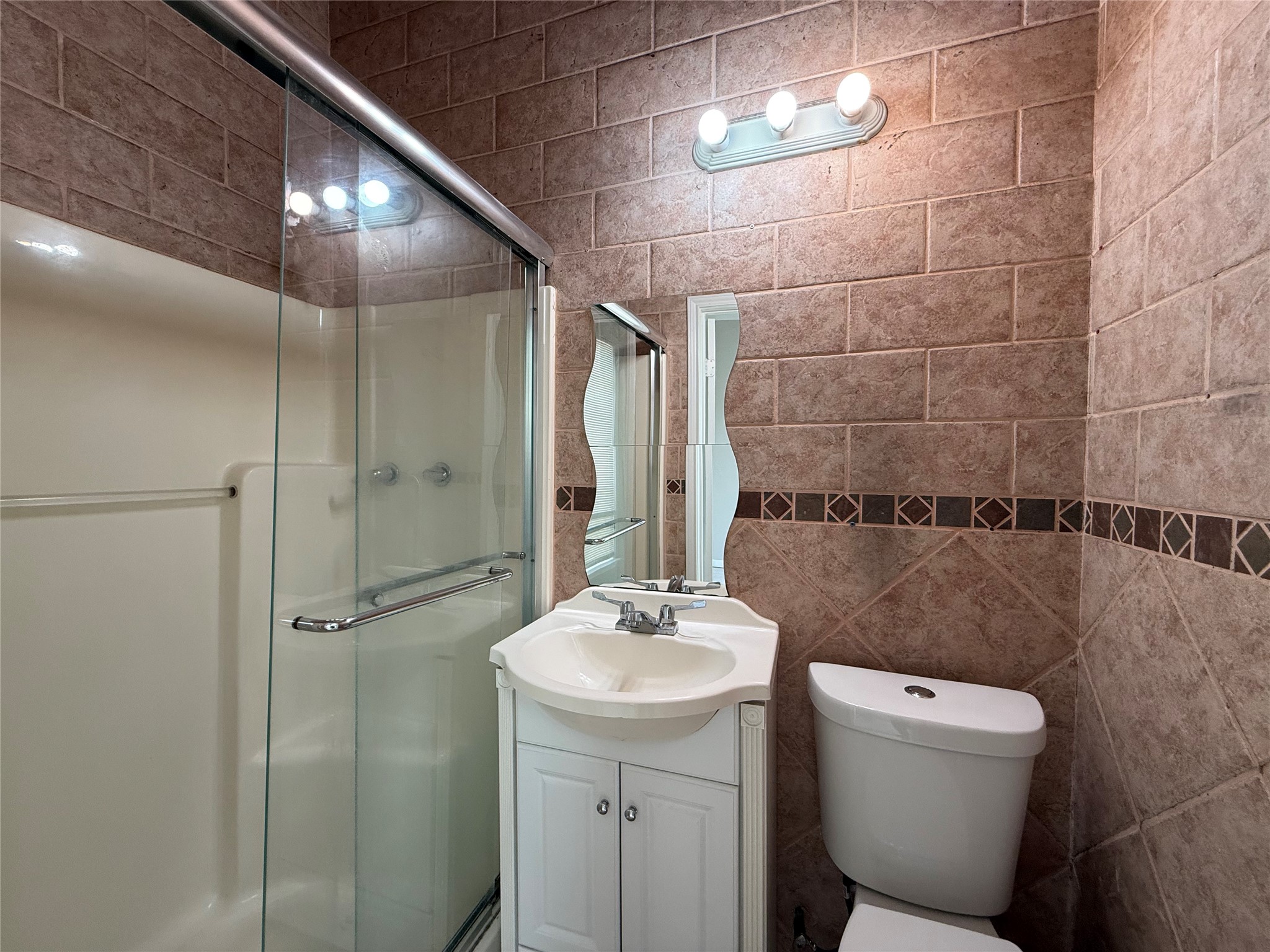 11346 Old Telegraph Road Houston, TX 77067 - Photo 12 of 20 a bathroom with a toilet sink and shower