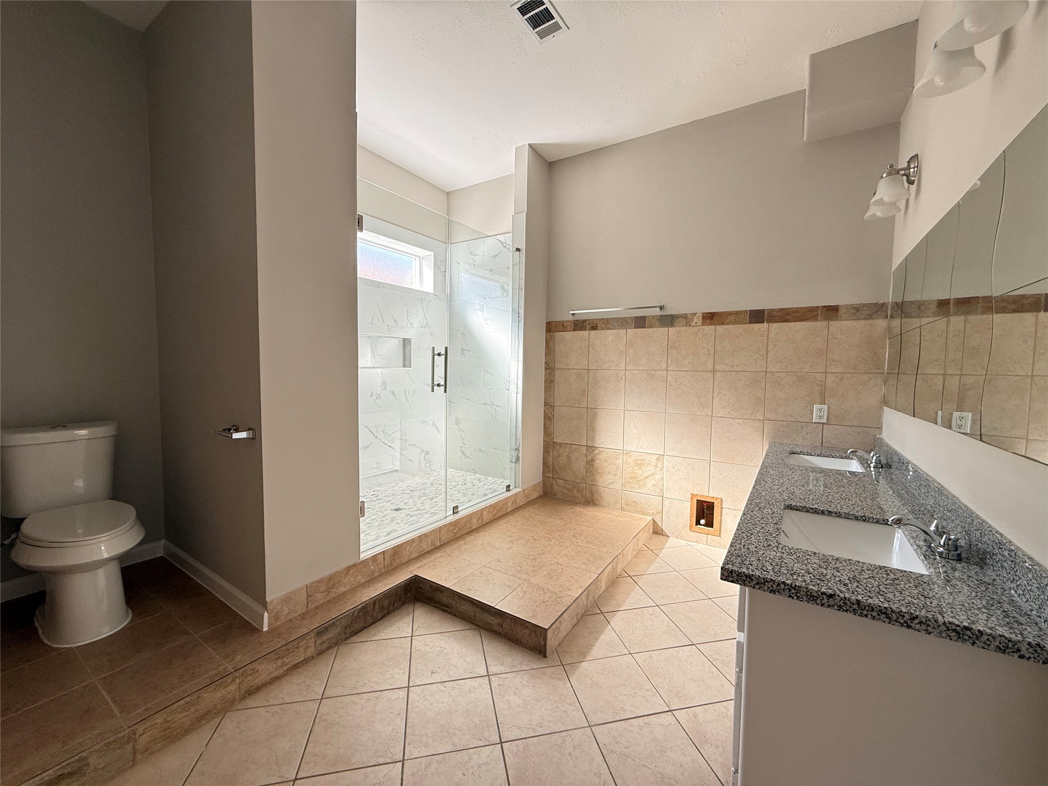 11346 Old Telegraph Road Houston, TX 77067 - Photo 14 of 20 a bathroom with a granite countertop sink a toilet and a mirror