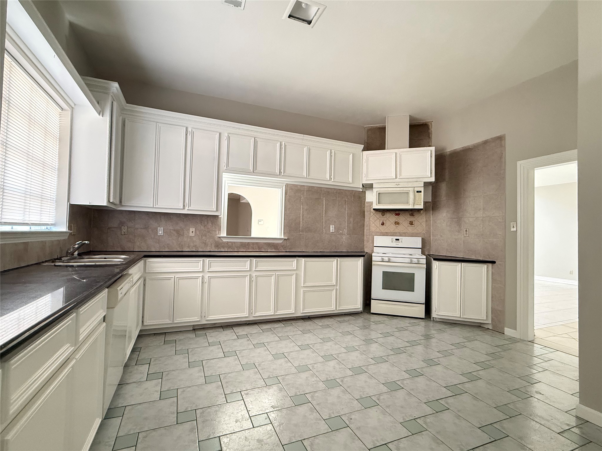 11346 Old Telegraph Road Houston, TX 77067 - Photo 8 of 20 a kitchen with stainless steel appliances granite countertop a stove a sink and a refrigerator