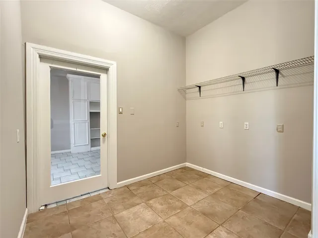an empty room with a ceiling fan and window