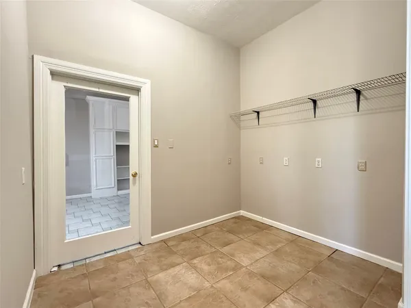 an empty room with a ceiling fan and window