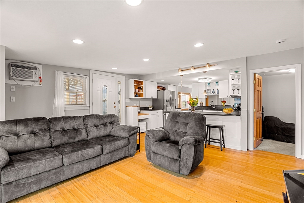 3 Adams Avenue Methuen, MA 01844 - Photo 17 of 37 a living room with furniture white walls and kitchen view