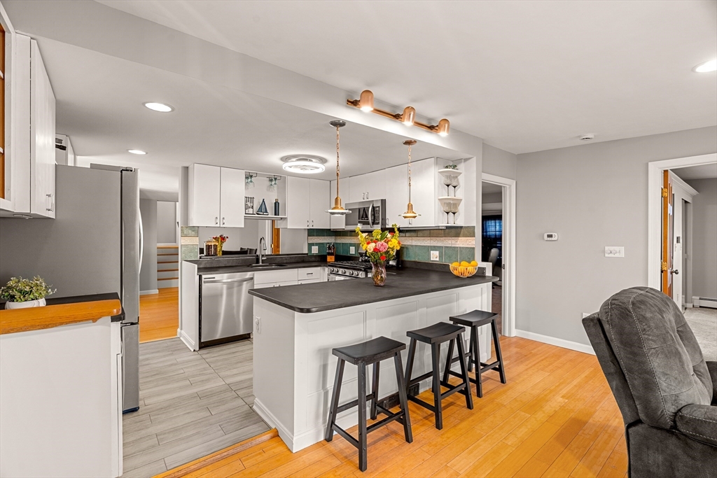 3 Adams Avenue Methuen, MA 01844 - Photo 5 of 37 a kitchen with stainless steel appliances granite countertop a table chairs and a refrigerator