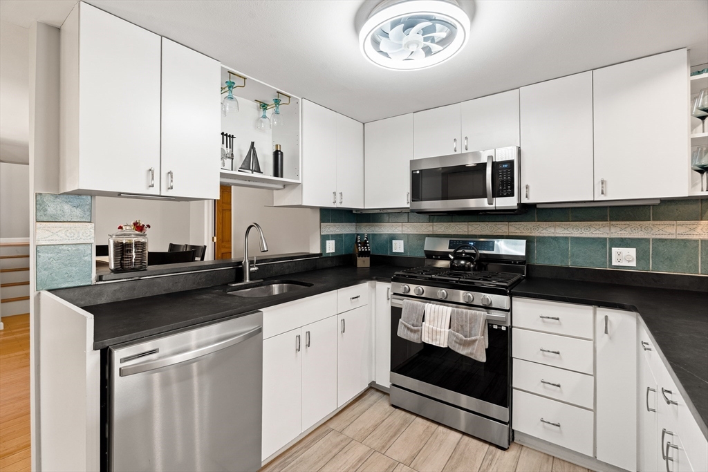 3 Adams Avenue Methuen, MA 01844 - Photo 8 of 37 a kitchen with stainless steel appliances granite countertop a sink and a stove