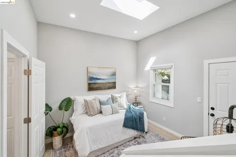 a kitchen with stainless steel appliances granite countertop a stove a refrigerator a sink dishwasher a dining table and chairs with wooden floor