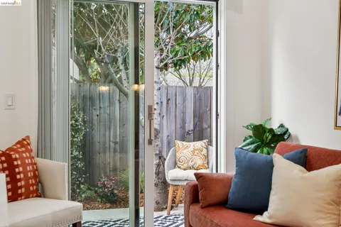 a bedroom with a bed and a lamp on dresser