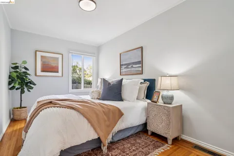 a bedroom with a bed and a potted plant