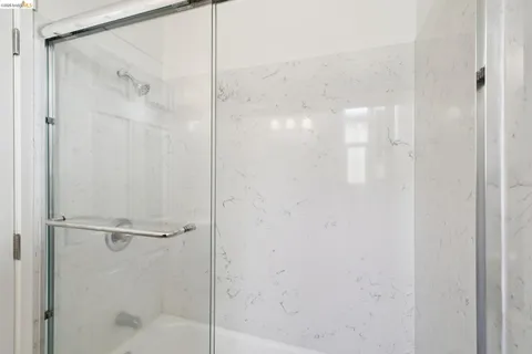 a bathroom with a glass shower door