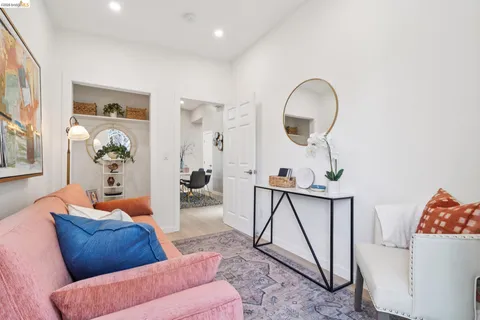 a living room with furniture a rug and white walls