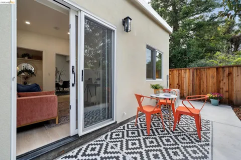 a backyard of a house with table and chairs