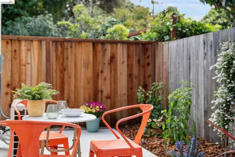 a wooden bench sitting in front of a wooden fence