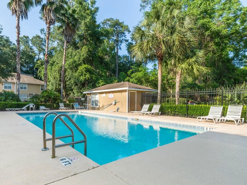 4415 Southwest 34th Street, Unit 607 Gainesville, FL 32608 - Photo 16 of 16 a view of a swimming pool with a patio and a yard