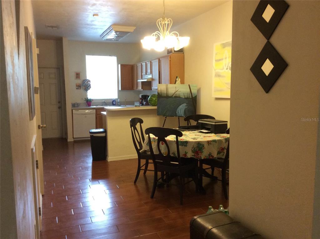 4415 Southwest 34th Street, Unit 607 Gainesville, FL 32608 - Photo 4 of 16 a view of a dining room with furniture and wooden floor