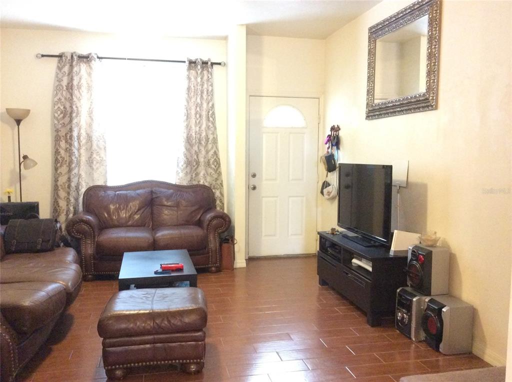 4415 Southwest 34th Street, Unit 607 Gainesville, FL 32608 - Photo 5 of 16 a living room with furniture and a flat screen tv