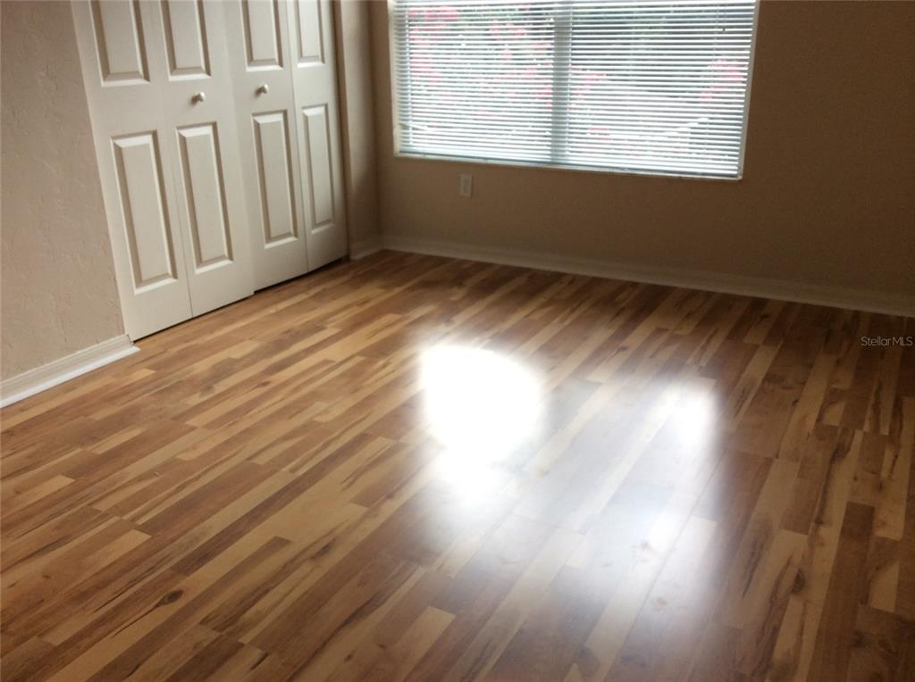 4415 Southwest 34th Street, Unit 607 Gainesville, FL 32608 - Photo 7 of 16 an empty room with wooden floor and windows