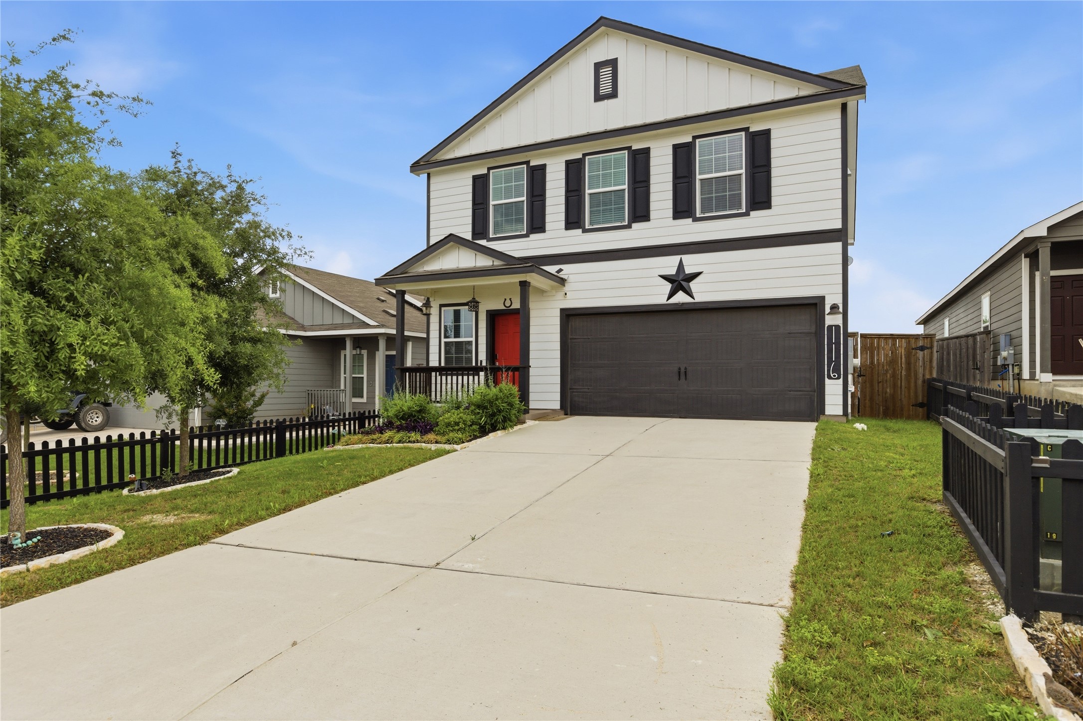 116 Night Riders Way Jarrell, TX 76537 - Photo 3 of 40 Two-story residence featuring white siding with dark trim accents and a black garage door