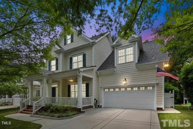 a front view of a house with a tree