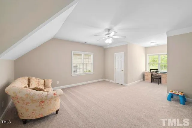 a spacious bedroom with a bed and a chandelier