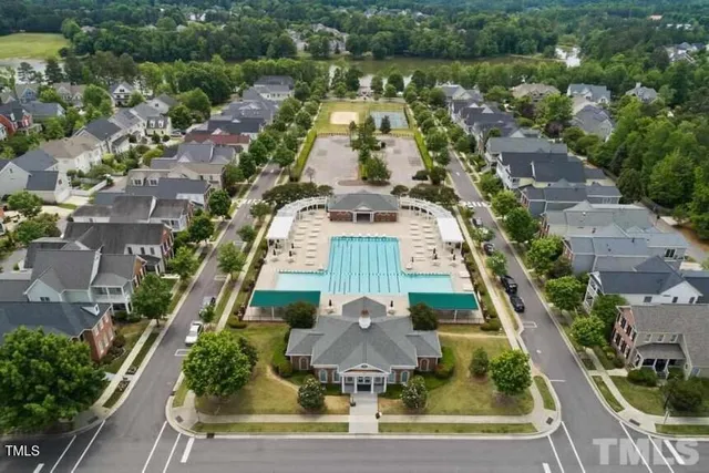 an aerial view of a house with a yard and lake view