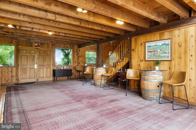 a dining room with furniture and a floor to ceiling window