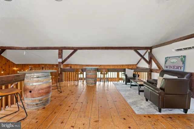a room with lots of wooden furniture and windows
