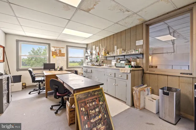 a kitchen with a cabinets a sink a counter top space and stainless steel appliances