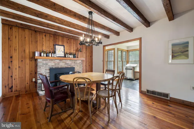 a view of a room with a large window and wooden floor