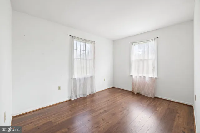 a sign that is on a flower in front of a building