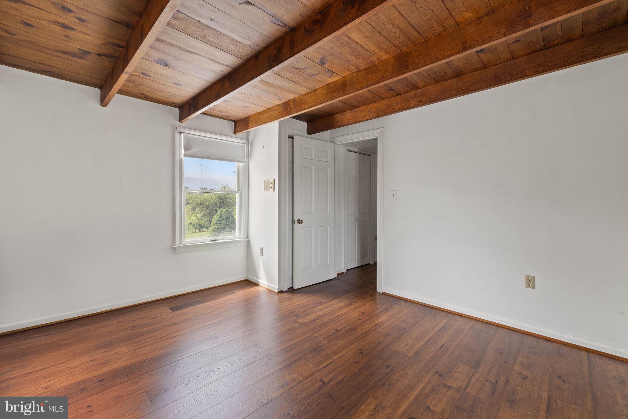 3659 South Ox Road Edinburg, VA 22824 - Photo 47 of 66 a view of an empty room with wooden floor and a window