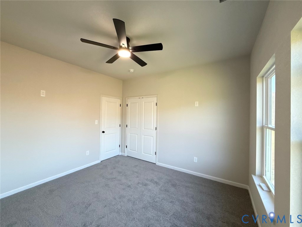 63 Hatcher Road Powhatan, VA 23139 - Photo 12 of 13 an empty room with a ceiling fan and window