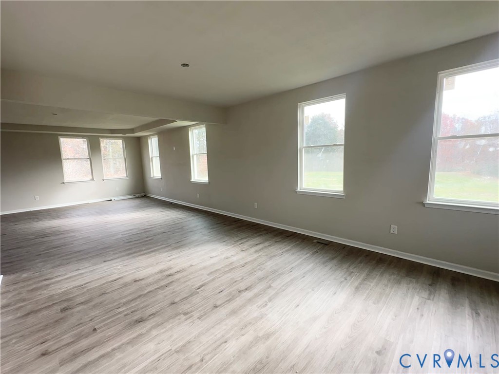 63 Hatcher Road Powhatan, VA 23139 - Photo 3 of 13 an empty room with wooden floor and windows