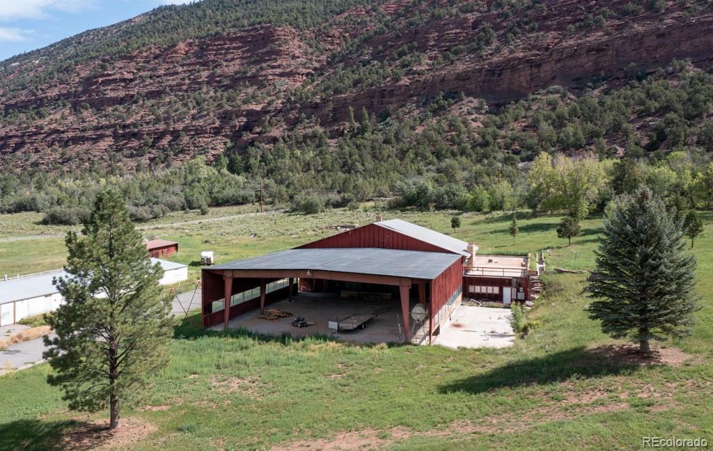131 Citadel, Unit RESIDE Ridgway, CO 81432 - Photo 16 of 25 an aerial view of a house with a yard table and chairs