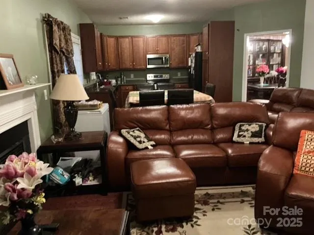 a living room with furniture a fireplace and a flat screen tv