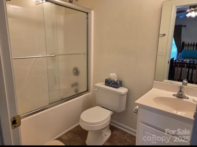 a bathroom with a toilet a sink and shower