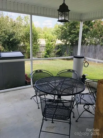 a view of a chairs and table in patio