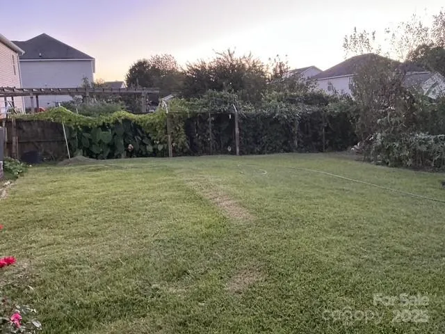 a view of a big yard with a building in the background