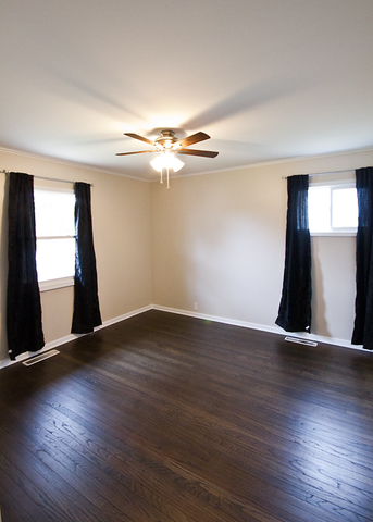 426 Thoria Road Batavia, IL 60510 - Photo 5 of 8 a view of an empty room with window and wooden floor
