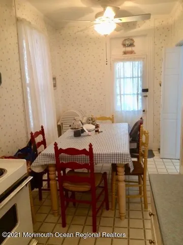 a dining room with furniture and window