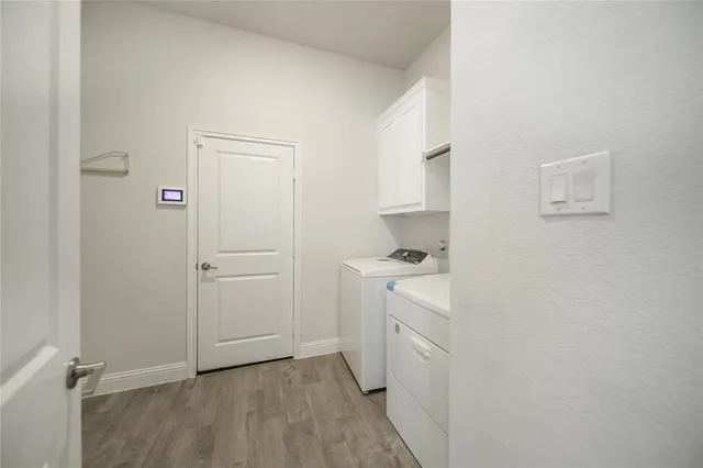a living room with furniture a fireplace and a large window