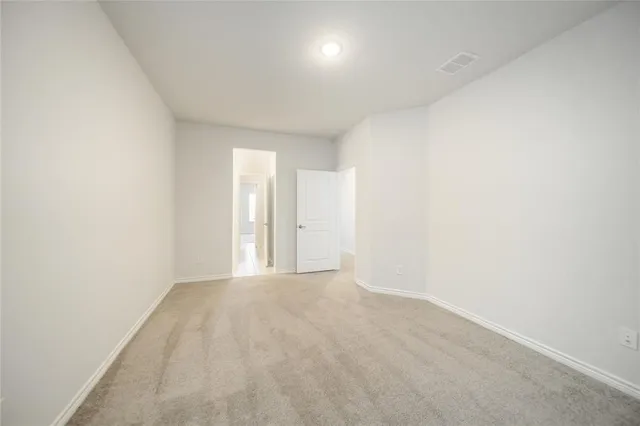 a bedroom with a bed and painting on the wall