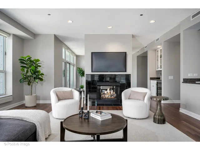 a living room with furniture a fireplace and a dining table