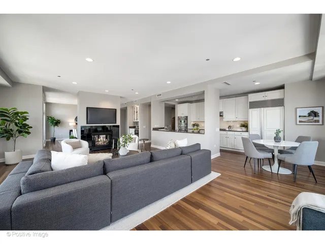 a kitchen with stainless steel appliances granite countertop a sink and a white cabinets